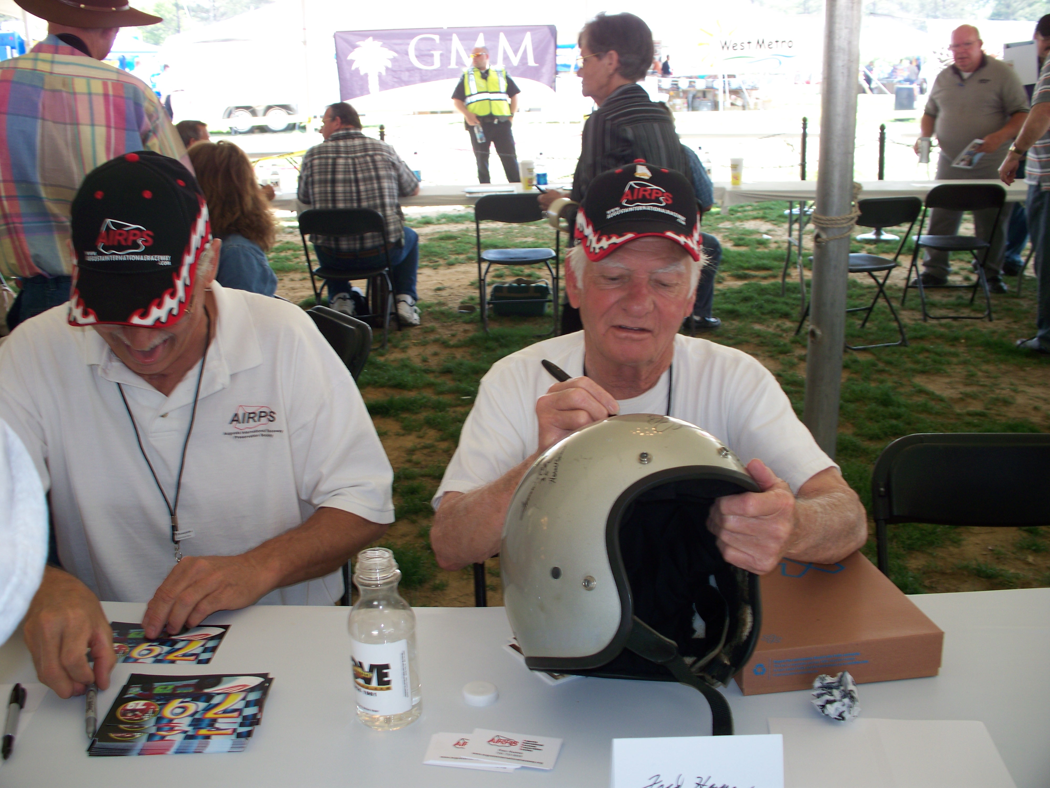 Jack Watson laughs while Fred Harper signs